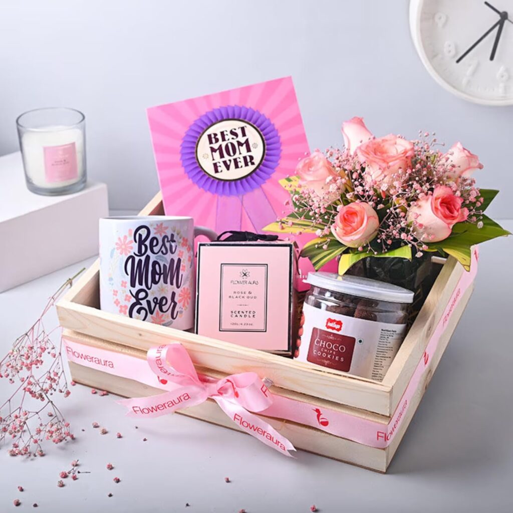 Explore FlowerAura's exquisite Mother's Day hamper, a thoughtful collection designed to celebrate mothers with beauty, taste, and sentimentality. Featuring elegant pink roses, a fragrant candle, a charming ceramic mug, indulgent choco cookies, and a heartfelt greeting card, this curated gift encapsulates the essence of maternal love. Ideal for expressing gratitude, the hamper offers a perfect blend of visual appeal and delightful aromas, ensuring a special day for mothers. With same-day delivery options, you can surprise your mom, even at the last minute. Celebrate your mother in a unique way with FlowerAura’s thoughtful gifts and create lasting memories this Mother's Day.